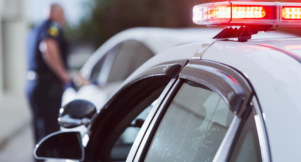 A file image of a police officer speaking to a driver in a car.