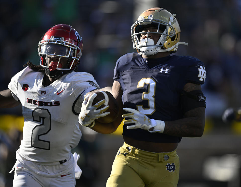 Notre Dame running back Logan Diggs (3) rush the ball past UNLV defensive back Nohl Williams (2) during the second half of an NCAA college football game, Saturday, Oct. 22, 2022, in South Bend, Ind. (AP Photo/Marc Lebryk)