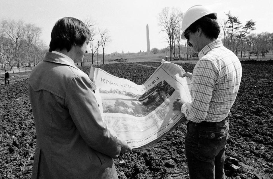 Jan Scruggs, left, president of the Vietnam Veterans Memorial Fund, and Gary Wright, the project engineer for the memorial, look over plans for the project in Washington on March 23, 1982. The memorial was built on the site near the Washington Monument. Groundbreaking was on March 26, 1982.