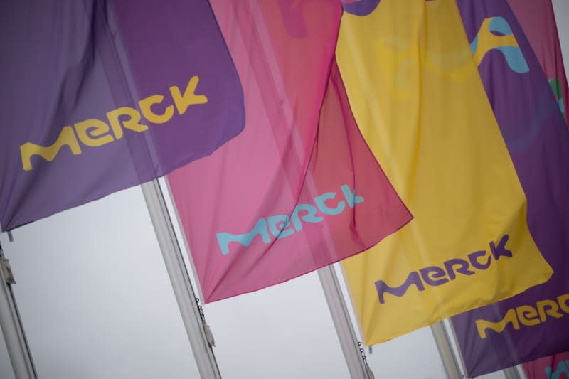 The logo of the pharmaceutical and chemical company Merck is displayed on flags on a building at its headquarters in Darmstadt. Sebastian Gollnow/dpa