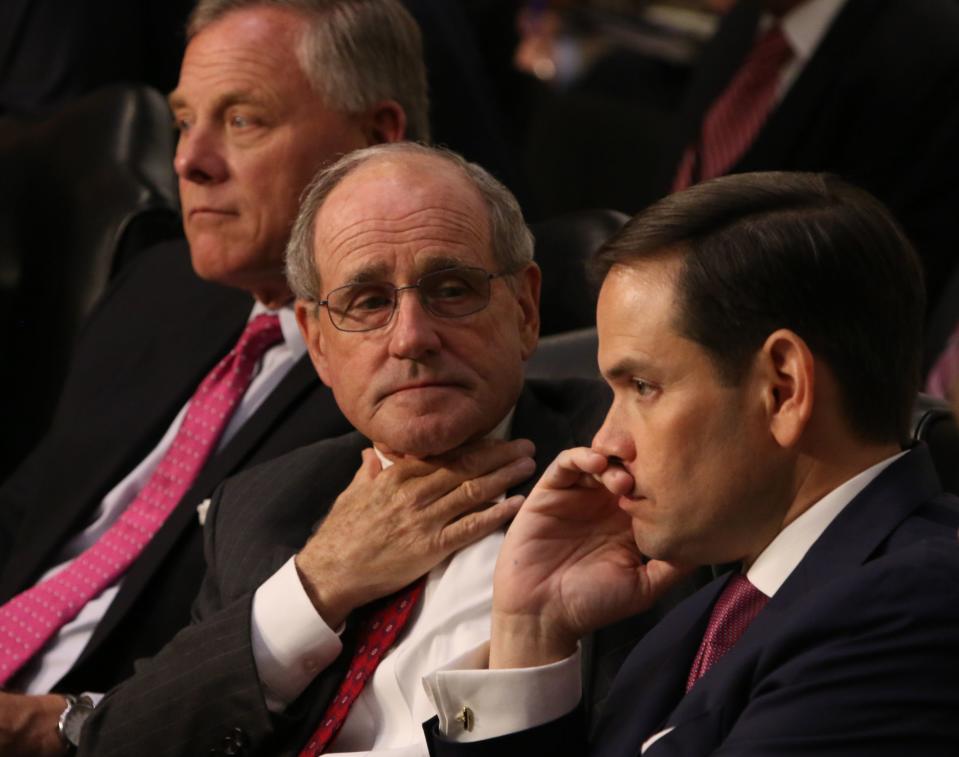 Senator James Risch adjusts his tie during the Senate Intelligence Committee hearing for former FBI director James Comey. FBI director James Comey testifies before the Senate Intelligence Committee as part of its investigation into Russia's interference in last year's presidential election and possible collusion between the Trump campaign and Russian officials, on June 8, 2017 in Washington.