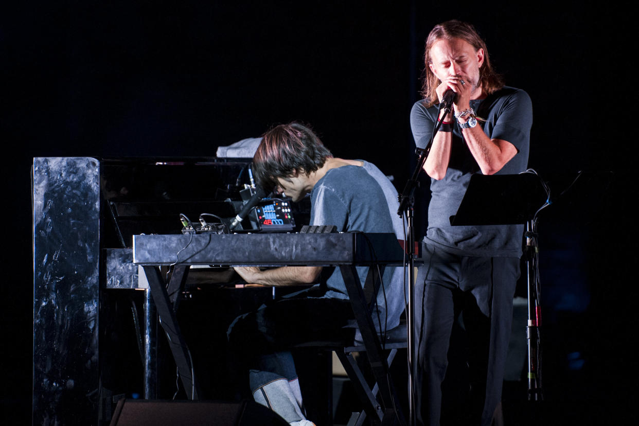 Thom Yorke and Jonny Greenwood (on piano) of the group Radiohead perform onstage on Aug. 20, 2017, in Macerata, Italy. (Photo: Roberto Panucci - Corbis via Getty Images)