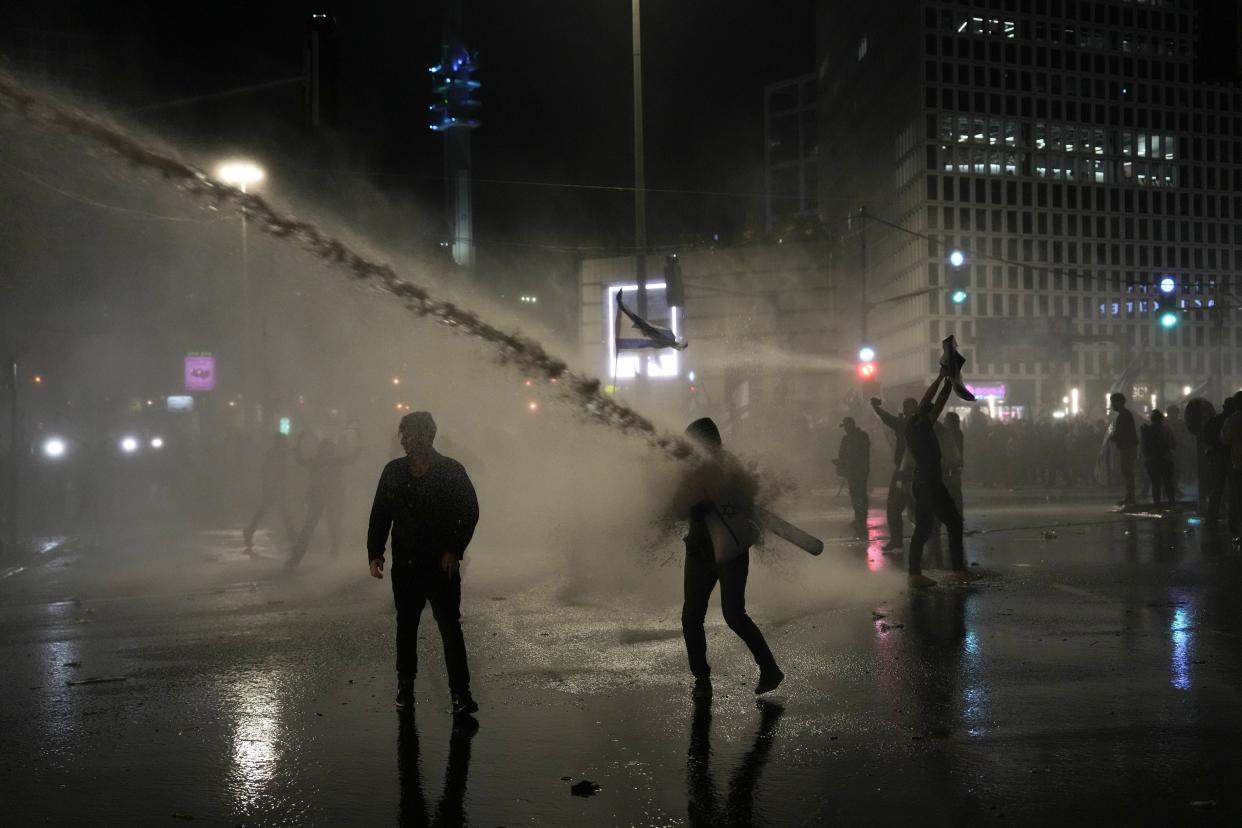 Israeli security forces use water canons to disperse protesters during ongoing demonstrations in Tel Aviv on March 27, 2023. (AP)
