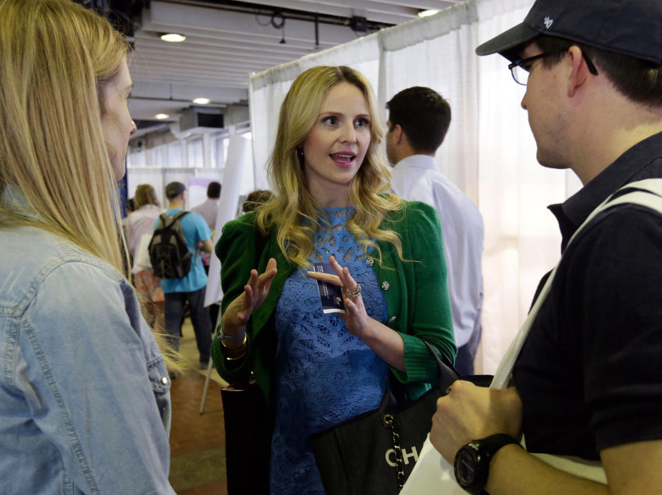 This May 18, 2013 photo shows pregnancy advise guru Rosie Pope, center, speaking with attendees at the New York Baby Show in New York. Pope is the author of the pregnancy guide, "Mommy IQ," and also has her own maternity clothing line. (AP Photo/Richard Drew, file)