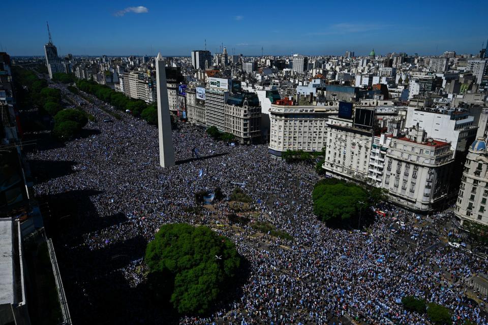 In this aerial view fans of Argentina wait for the bus with Argentina's players to pass through the Obelisk to celebrate after winning the Qatar 2022 World Cup tournament in Buenos Aires on December 20, 2022.