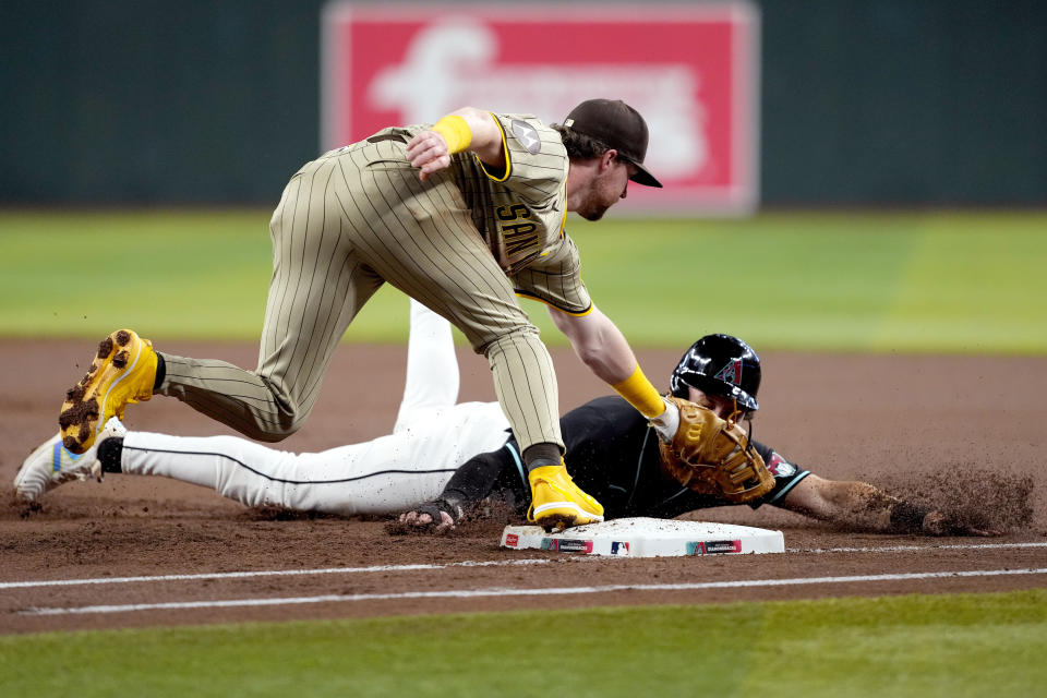Arizona Diamondbacks' Jake McCarthy, right, is picked-off first by San Diego Padres pitcher Michael King as Jake Cronenworth makes the tag during the first inning of a baseball game, Saturday, May 4, 2024, in Phoenix. (AP Photo/Matt York)