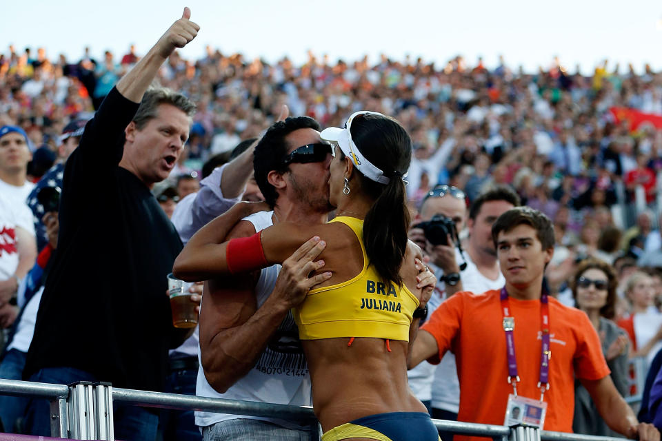 LONDON, ENGLAND - AUGUST 08: Juliana Silva of Brazil climbs into the crowd as she celebrates winning the Bronze medal in the Women's Beach Volleyball Bronze medal match against China on Day 12 of the London 2012 Olympic Games at the Horse Guard's Parade on August 8, 2012 in London, England. (Photo by Jamie Squire/Getty Images)