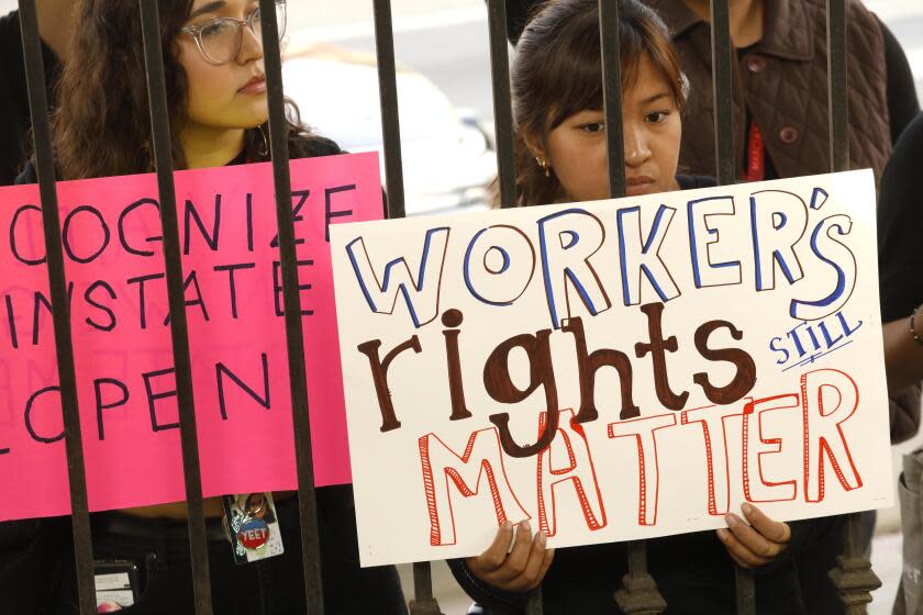 WEST HOLLYWOOD, CA - NOVEMBER 15, 2019 - - Nina Gibson, from left, and Anna Calubayan join fellow Marciano Art Foundation workers, recently laid off, in a protest in front of LAXART along Santa Monica Blvd. in West Hollywood on November 15, 2019. Labor organizers in Los Angeles have accused the Marciano Art Foundation, a private museum, of violating federal law by dismissing 70 employees after they announced that they wanted to form a union. Workers chose this site to protest because Olivia Marciano, the Foundation's Artistic Director, is on the board at LAXART. Gibson and Calubayan were both visitor services associates at the MAF. (Genaro Molina / Los Angeles Times)