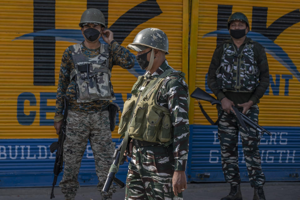 Paramilitary soldiers patrol a deserted street on the first anniversary of India’s decision to revoke the disputed region’s semi-autonomy, in Srinagar, Indian controlled Kashmir, Wednesday, Aug. 5, 2020. Last year on Aug. 5, India’s Hindu-nationalist-led government of Prime Minister Narendra Modi stripped Jammu-Kashmir of its statehood and divided it into two federally governed territories. Late Tuesday, authorities lifted a curfew in Srinagar but said restrictions on public movement, transport and commercial activities would continue because of the coronavirus pandemic. (AP Photo/ Dar Yasin)