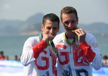 2016 Rio Olympics - Triathlon - Men's Victory Ceremony - Fort Copacabana - Rio de Janeiro, Brazil - 18/08/2016. Alistair Brownlee (GBR) of Great Britain and Jonathan Brownlee (GBR) of Great Britain pose with their gold and silver medals. REUTERS/Toby Melville
