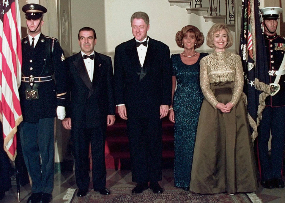 FILE - President Bill Clinton and first lady Hillary Clinton pose with Chile's President Eduardo Frei, left, and his wife Marta Larraecha De Frei as they arrive at the White House for a state dinner Feb. 26, 1997.(AP Photo/Ruth Fremson, File)