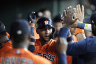 Houston Astros' Yuli Gurriel celebrates in the dugout after hitting a home run against the Los Angeles Angels during the second inning of a baseball game Friday, July 1, 2022, in Houston. (AP Photo/David J. Phillip)