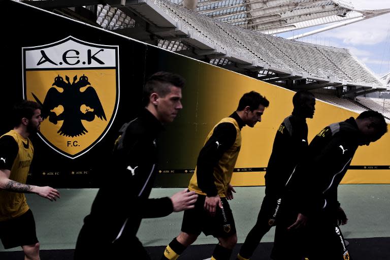 AEK Athens FC players enter the pitch on April 4, 2015 for a game against Alimos FC at OAKA Stadium in Athens