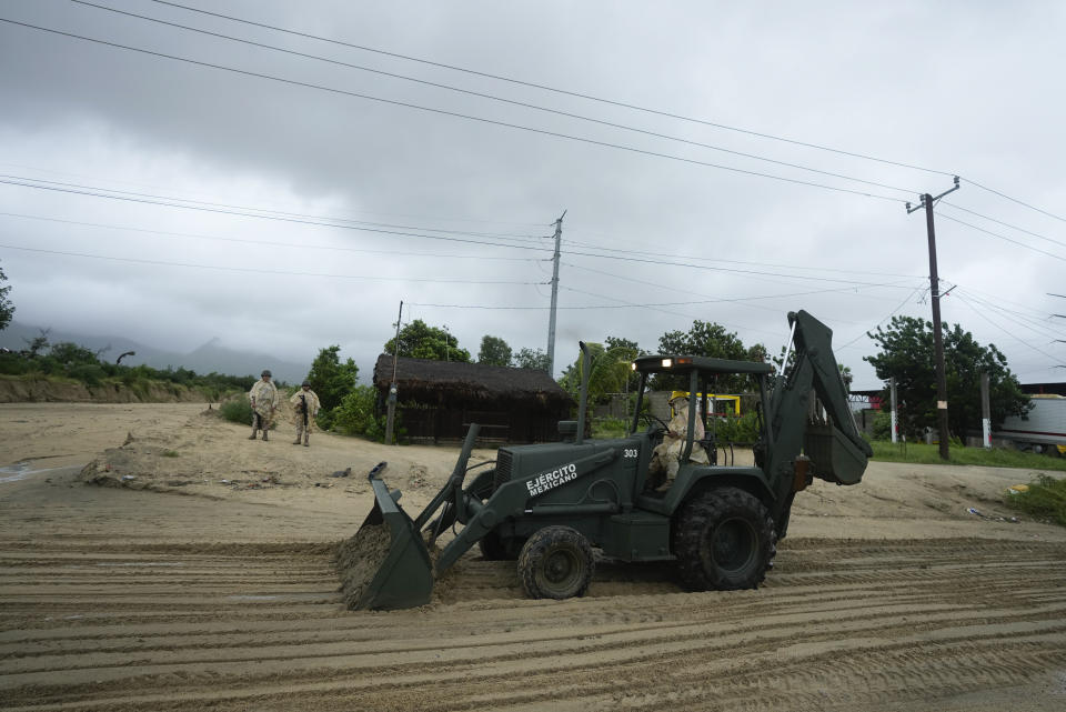 Mexican soldiers remove mud and sludge from a avenue flooded by the rains of Hurricane Norma in San Jose del Cabo, Mexico, Saturday, Oct. 21, 2023. Norma had weakened and was downgraded to Category 1 on the hurricane wind scale. It was located 25 miles west of Cabo San Lucas storm with winds of 85 mph (140 kmh) and expected to make landfall on Saturday, according to the U.S. (AP Photo/Fernando Llano)