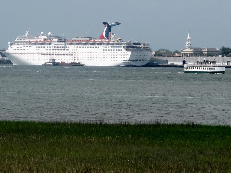 This April 18, 2012, photo taken from the Mount Pleasant, S.C. side of the Cooper River shows the Carnival Fantasy at a dock in Charleston. For more than two years the debate over cruise ships calling year-round in Charleston has raged with a state Supreme Court case, conflicting economic studies and rhetoric. Preservationists cite the threat to the city's historic character while cruise supporters say the industry is being administered appropriately and provides needed jobs and a boost to the local economy. (AP Photo/Bruce Smith)