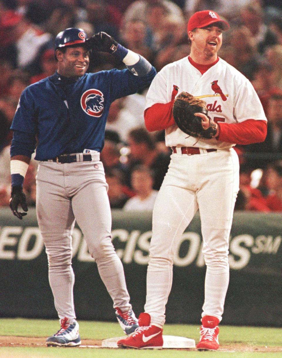 Mark McGwire talks with Sammy Sosa, left, during their home run chase in the summer of 1998.