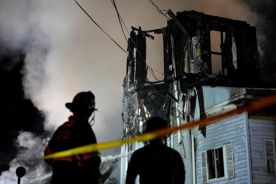 Firefighters work at the scene where two police officers were injured while responding to reported standoff in East Lansdowne, Pa., on Wednesday, Feb. 7.