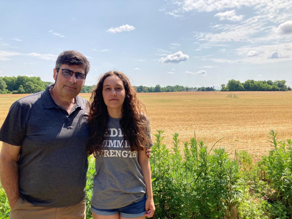 Allentown residents Rick Jakober and his daughter Kirstin  Jakober in their backyard, which opens to a field that may soon become a warehouse complex.