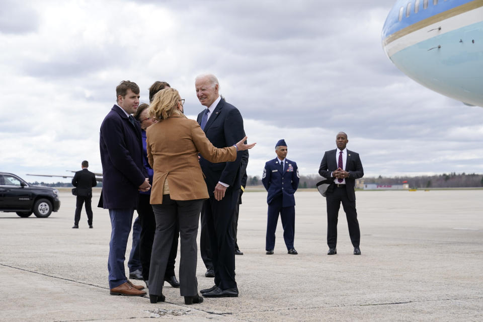 President Joe Biden speaks with officials after stepping off Air Force One at Portsmouth International Airport at Pease in Portsmouth, N.H., Tuesday, April 19, 2022. Biden is in New Hampshire to promote his infrastructure agenda. (AP Photo/Patrick Semansky)