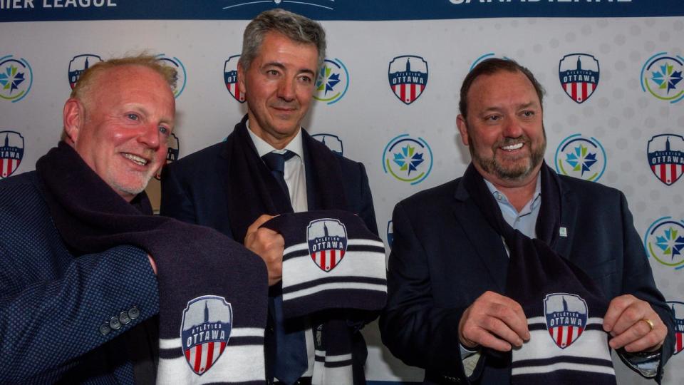 From left: Partner Jeff Hunt, Atlético de Madrid CEO Miguel Ángel Gil Marín and Canadian Premier League commissioner David Clanachan unveil Atlético Ottawa's logo Feb. 11, 2020.
