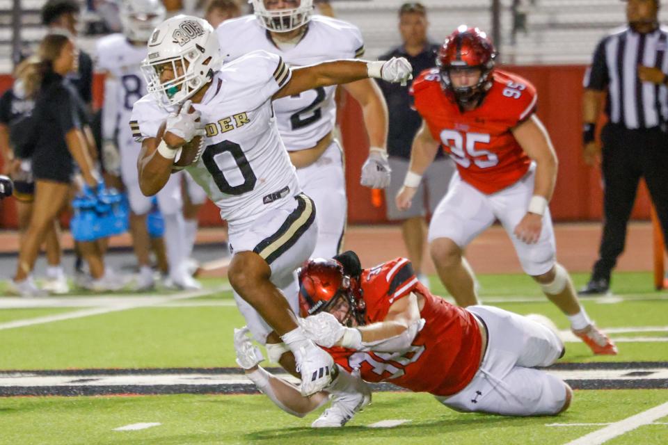 Wichita Falls Rider’s Jordon Gibbs (0) breaks a tackle against Lubbock-Cooper in a Sept. 16 game at Pirate Stadium in Woodrow.