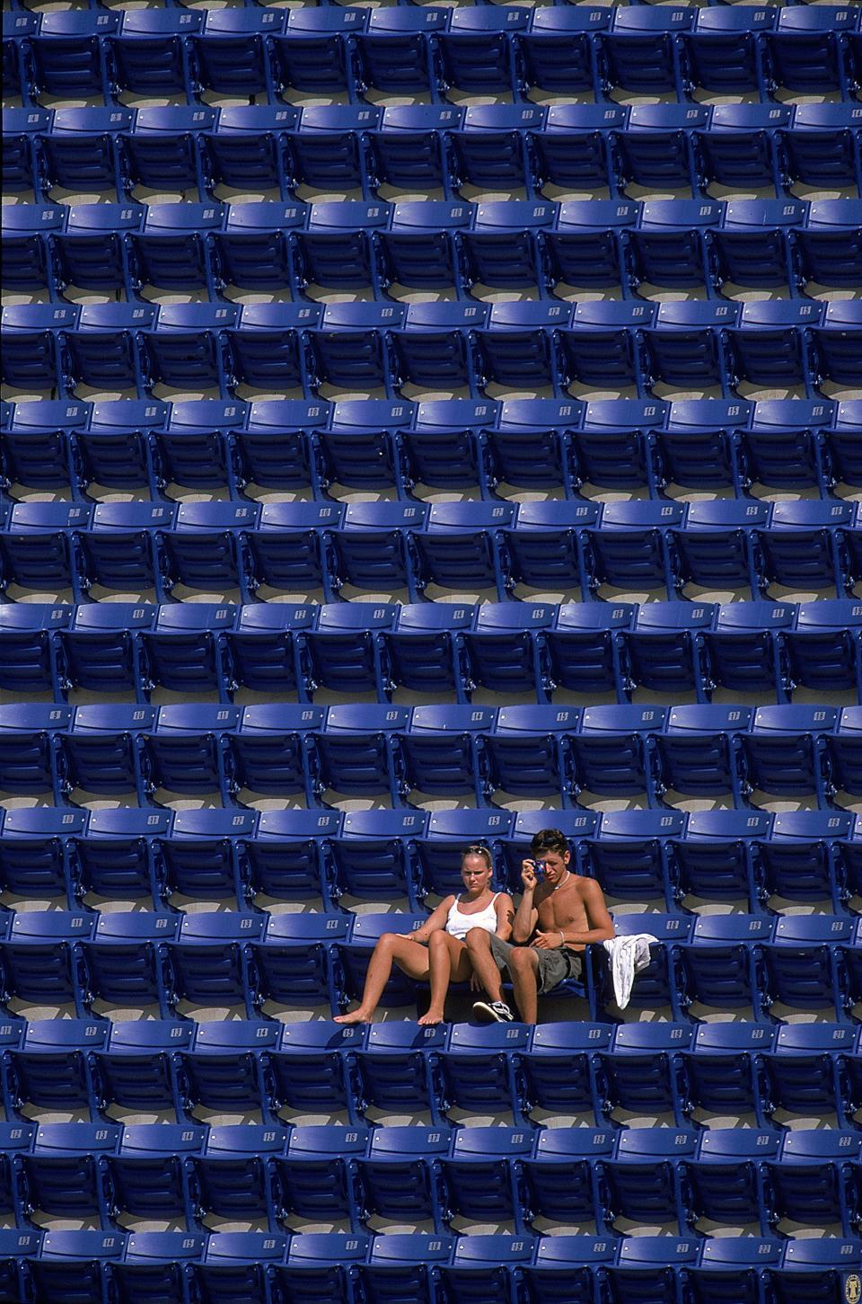 A view of two fans in a field of empty seats during a game between the Philadelphia Phillies and the Arizona Diamondbacks at the Veterans Stadium in Philadelphia, Pennsylvania. The Diamondbacks defeated the Phillies 8-2. (Photo by Doug Pensinger/Allsport via Getty Images)