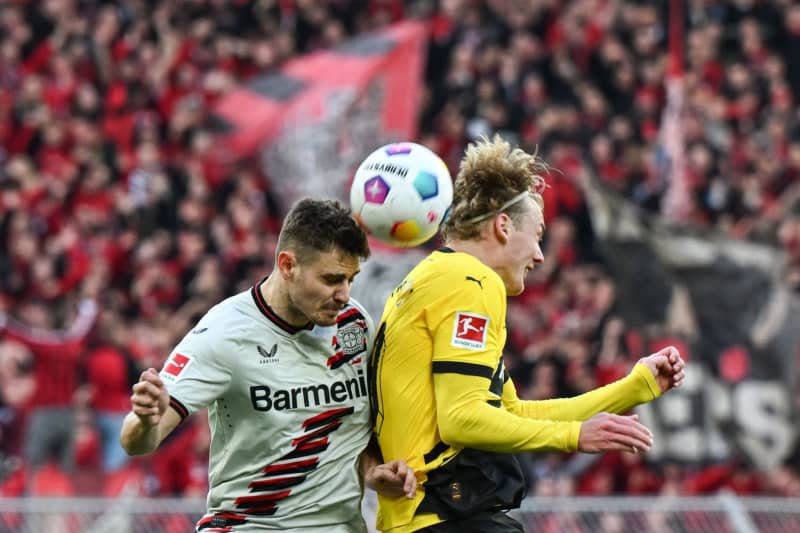 Leverkusen's Josip Stanisic and Dortmund's Julian Brandt battle for the ball during the German Bundesliga soccer match between Borussia Dortmund and Bayer Leverkusen at Signal Iduna Park. Federico Gambarini/dpa