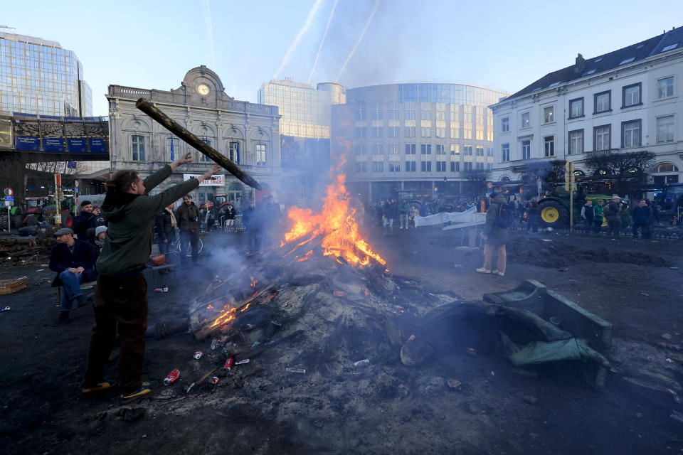 One of the statues surrounding John Cockerill's monument in Luxembourg square lies on the ground during a protest by farmers outside the European Parliament as European leaders meet for an EU summit in Brussels, Thursday, Feb. 1, 2024. European Union leaders meet in Brussels for a one day summit to discuss the revision of the Multiannual Financial Framework 2021-2027, including support for Ukraine. (AP Photo/Geert Vanden Wijngaert)