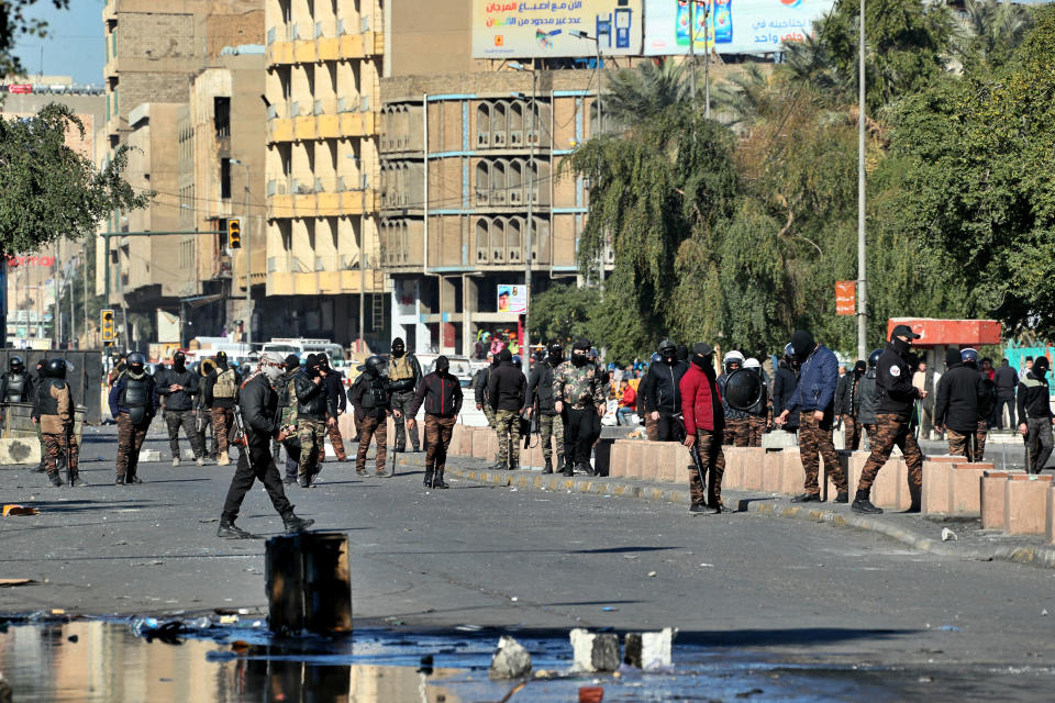 Security forces try to disperse anti-government protesters during clashes in Baghdad, Iraq, Sunday, Jan. 26, 2020. (AP Photo/Hadi Mizban)