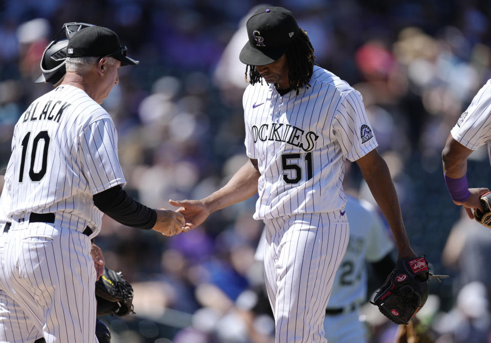 Colorado Rockies manager Bud Black, left, takes the ballp from starting pitcher Jose Urena as he is pulled form the mound after giving up a double to Texas Rangers' Mark Mathias to allow in three runs in the second inning of a baseball game Wednesday, Aug. 24, 2022, in Denver. (AP Photo/David Zalubowski)