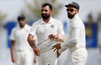 Cricket - Sri Lanka v India - First Test Match - Galle, Sri Lanka - July 27, 2017 - India's cricketer Mohammed Shami celebrates with captain Virat Kohli after taking the wicket of Sri Lanka's Danushka Gunathilaka (not pictured) . REUTERS/Dinuka Liyanawatte