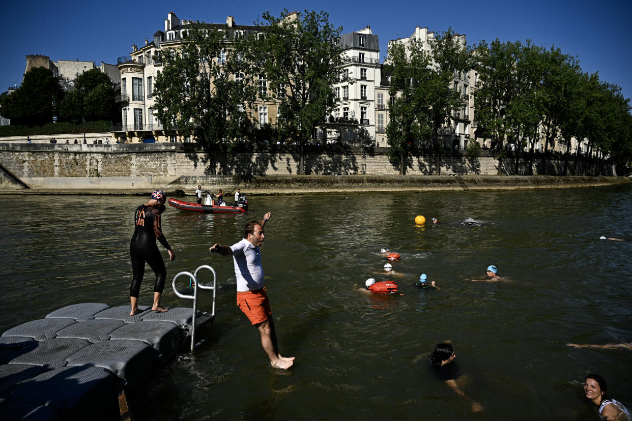 A local resident jumps into the Seine. (Julien De Rosa/AFP via Getty Images)