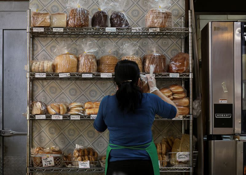 FILE PHOTO: A baker stocks shelfs with bread at the Eastern Market in Washington