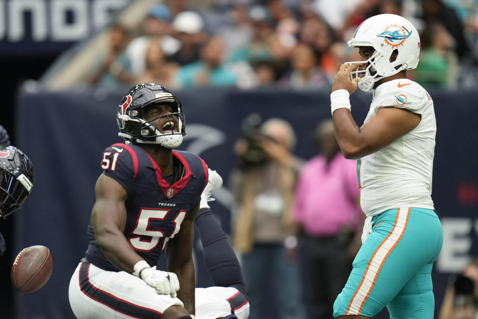 Houston Texans defensive end Will Anderson Jr. (51) reacts after after a tackle against Miami Dolphins running back Raheem Mostert, not visible, as Dolphins quarterback Tua Tagovailoa, right, looks on during the first half of an NFL preseason football game, Saturday, Aug. 19, 2023, in Houston. (AP Photo/Eric Christian Smith)