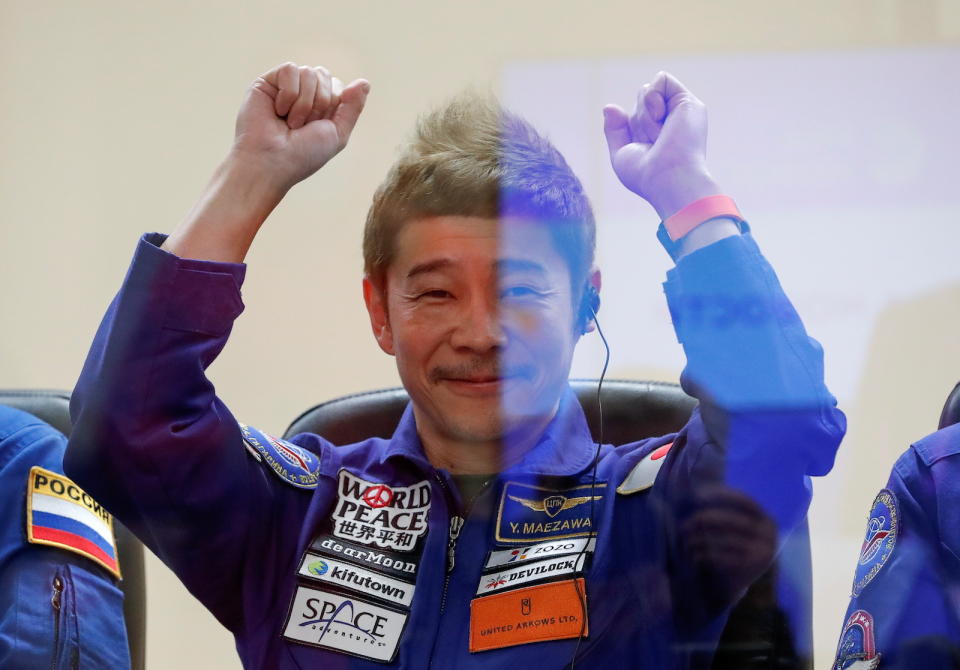 Japanese entrepreneur and space flight participant Yusaku Maezawa gestures behind a glass wall during a news conference in Baikonur, Kazakhstan December 7, 2021. Maezawa, Roscosmos cosmonaut Alexander Misurkin and flight participant Yozo Hirano take part in a mission to the International Space Station (ISS) scheduled for December 8, 2021. REUTERS/Shamil Zhumatov/Pool