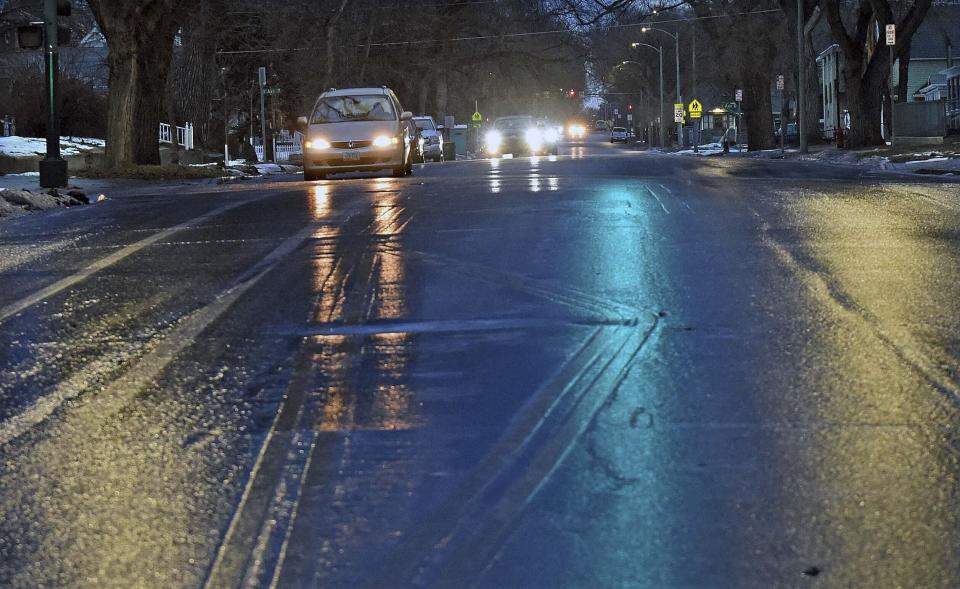 The intersection of Fourth Street and Avenue C in Bismarck, N.D., is seen on Tuesday morning, Dec. 26, 2023, as ice covered streets and sidewalks made walking and driving difficult. (Tom Stromme/The Bismarck Tribune via AP)