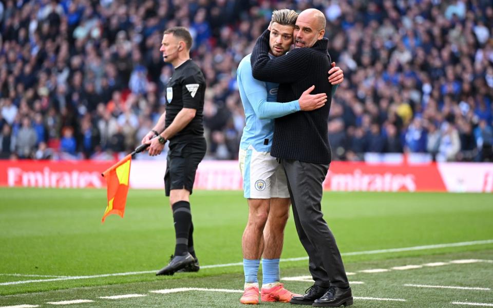 Everything feels better after a hug...Grealish is consoled by Guardiola