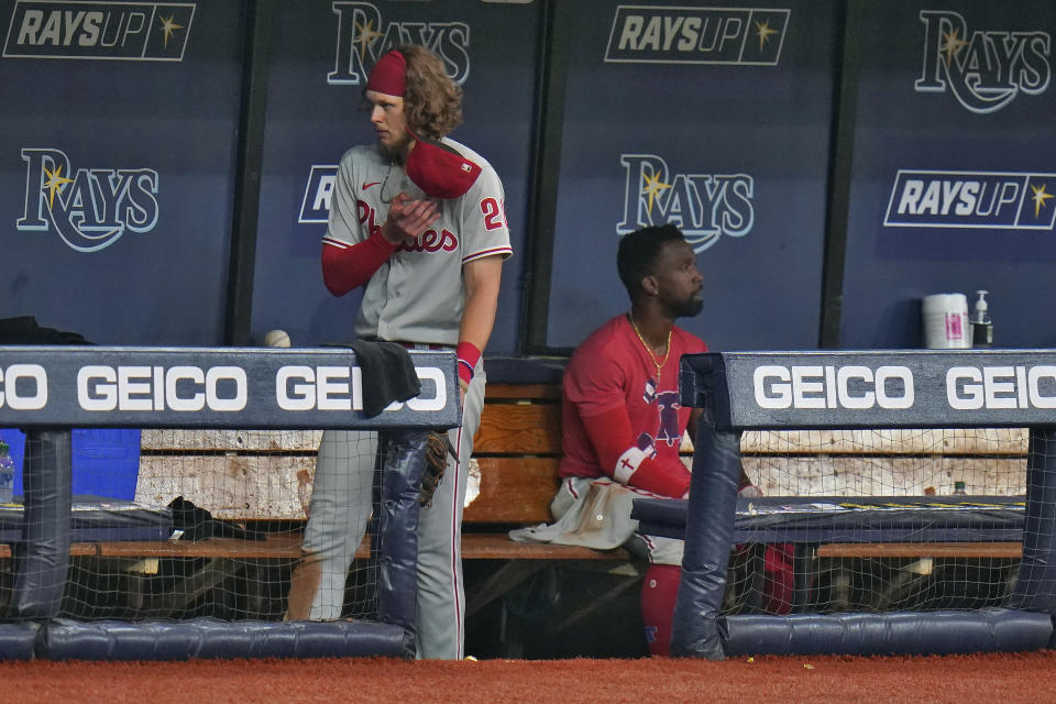 Philadelphia Phillies' Alec Bohm, left, and Andrew McCutchen remain in the dugout after the team lost to the Tampa Bay Rays during a baseball game Saturday, Sept. 26, 2020, in St. Petersburg, Fla. (AP Photo/Chris O'Meara)