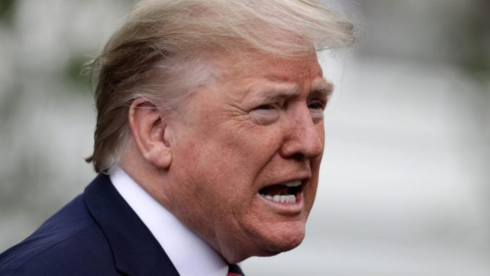 President Donald Trump talks to journalists as he departs the White House. (Photo by Chip Somodevilla/Getty Images)