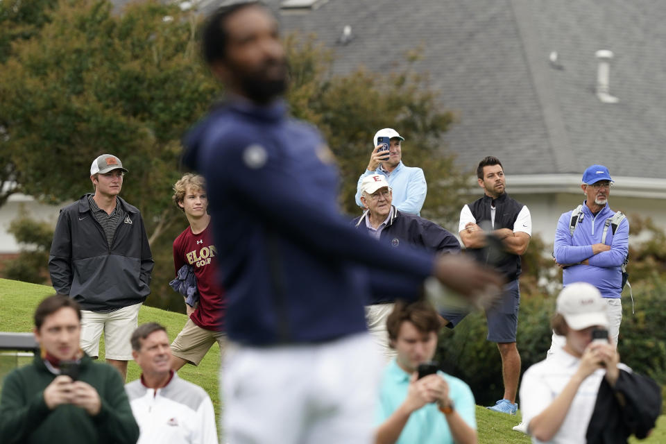 Fans watch as North Carolina A&T's J.R. Smith hits a tee shot on the first hole during the first round of the Phoenix Invitational golf tournament in Burlington, N.C., Monday, Oct. 11, 2021. Smith, who spent 16 years in the NBA made his college golfing debut in the tournament hosted by Elon. (AP Photo/Gerry Broome)