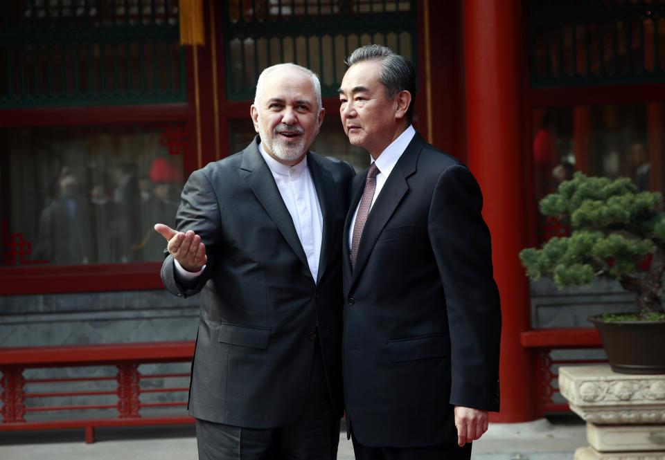 Iranian Foreign Minister Mohammad Javad Zarif, left, gestures as he speaks with his Chinese counterpart Wang Yi during their meeting at the Diaoyutai State Guesthouse in Beijing Tuesday, Feb. 19, 2019. (How Hwee Young/Pool Photo via AP)
