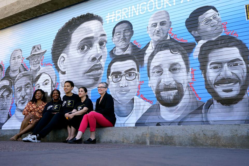 From left; Artist Antoinette Cauley, Cherelle Griner, WNBA basketball player Brittney Griner, Neda Sharghi, chair of Bring Our Families Home, and Arizona Gov. Katie Hobbs pose for photographers after unveiling a 30-foot mural depicting individuals detained abroad, Thursday, April 27, 2023, outside the Footprint Center in Phoenix. Griner has promised to keep fighting to free other detained Americans.