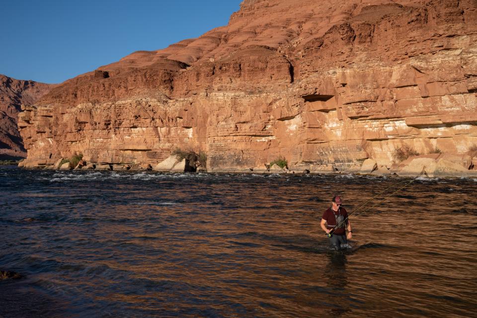 Daniel Wenzel, of Tucson, walks downstream while fishing for trout fishing in the Colorado River at Lees Ferry on May 24, 2022. Upper Basin states must deliver at least 7.5 million acre-feet past this point on average – a requirement that threatens to cut off future water development upstream unless it is loosened.