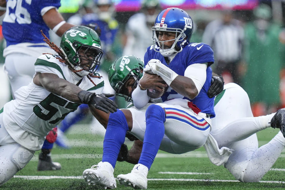 New York Giants quarterback Tyrod Taylor (2) is tackled on the run by New York Jets linebacker C.J. Mosley, behind, during the first half of an NFL football game, Sunday, Oct. 29, 2023, in East Rutherford, N.J. (AP Photo/Frank Franklin II)