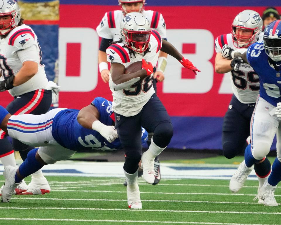 Patriots running back Rhamondre Stevenson (38) rushes for a first down run against the New York Giants in Sunday's game.