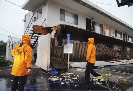 A second-story walkway to apartment units is shown after it collapsed during heavy rains in Long Beach, California, December 12, 2014. REUTERS/Bob Riha Jr.