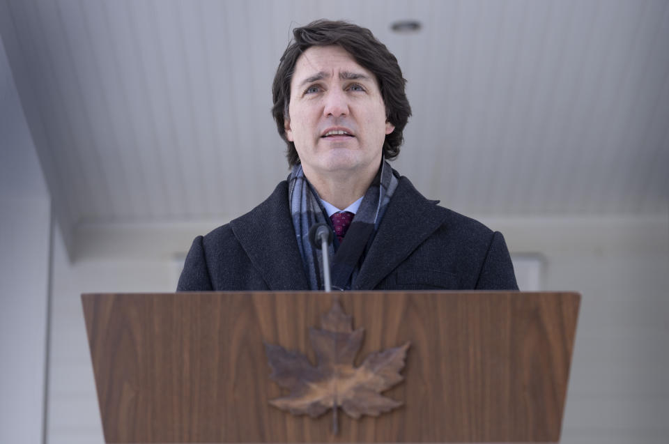 Canadian Prime Minister Justin Trudeau speaks with the media during his first availability after announcing he has COVID-19 at a location in the National Capital Region, Monday, Jan. 31, 2022. Trudeau announced Monday he has tested positive for COVID-19 but is “feeling fine” and will continue to work remotely from home. (Adrian Wyld/The Canadian Press via AP)