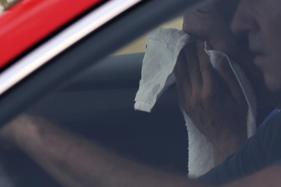 France's Thibaut Pinot wipes his face in the car of team director during the nineteenth stage of the Tour de France cycling race over 126,5 kilometers (78,60 miles) with start in Saint Jean De Maurienne and finish in Tignes, France, Friday, July 26, 2019. Pinot's remarkable Tour de France ended in pain and tears within touching distance of Paris as the Frenchman was forced to abandon the race with a left leg injury on Friday. (AP Photo/Thibault Camus)