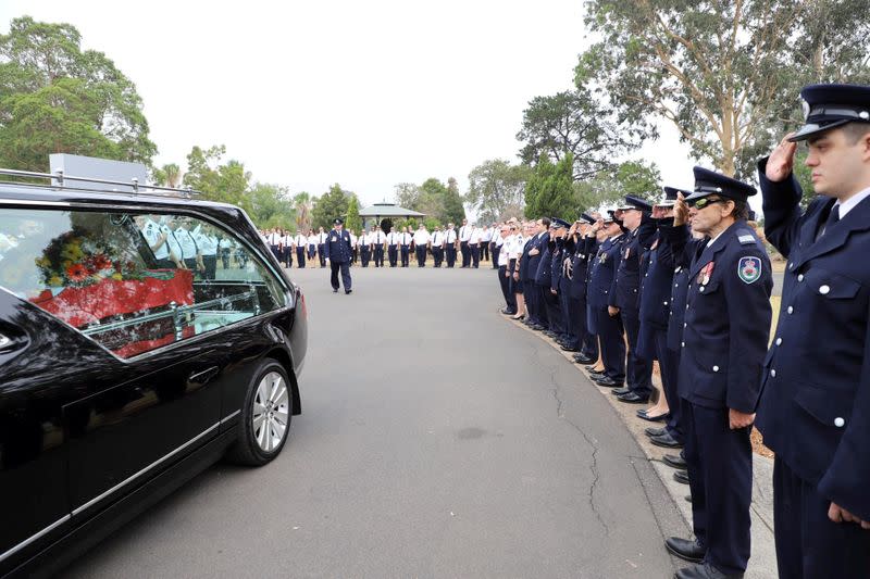 A hearse transporting the coffin of late RFS volunteer Keaton is seen during his funeral in Buxton