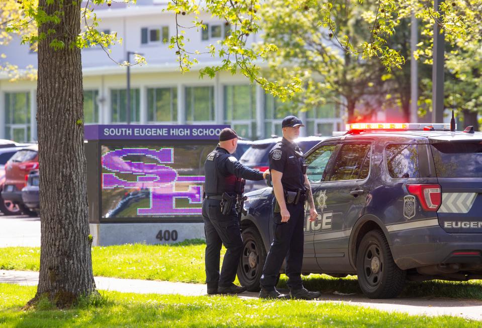 Police at the front entrance to South Eugene High School on May 10 after a report of a bomb was received by officials. No device was found.